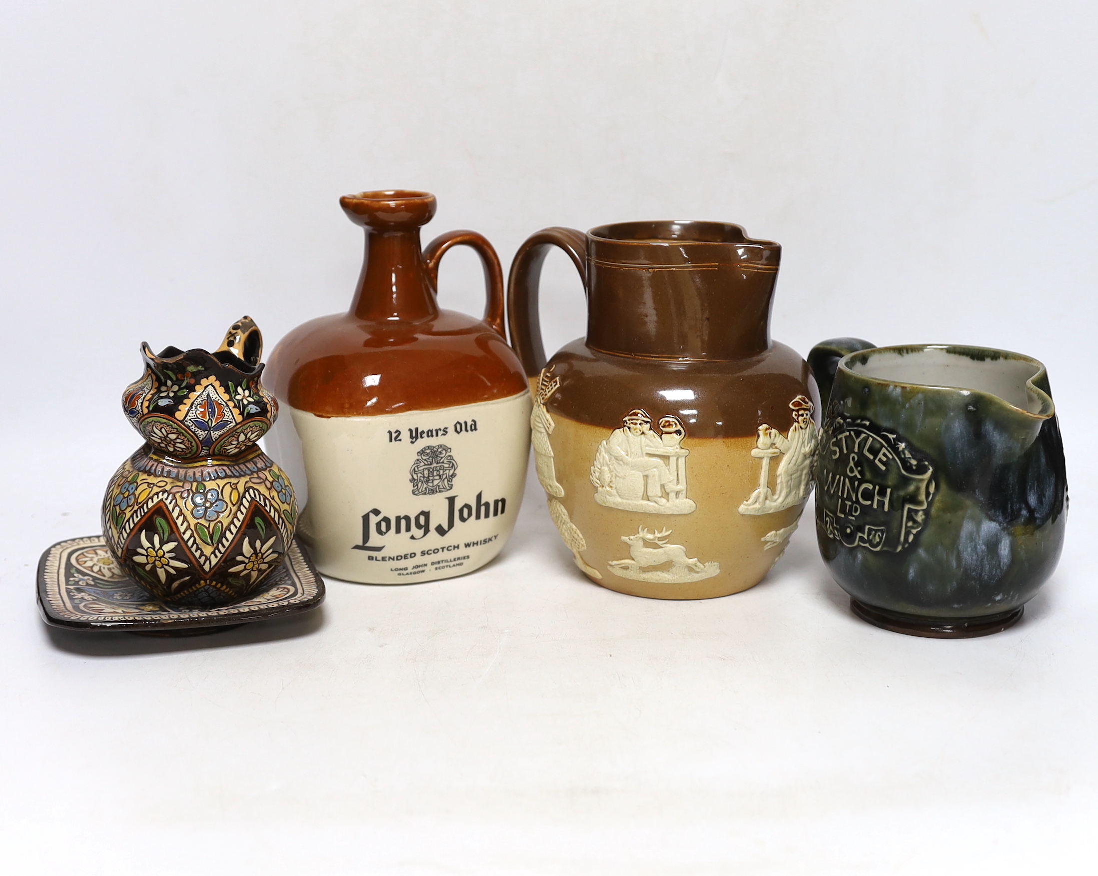 Three Thoune glazed earthenware items comprising dish, jug and vase, two signed to the base, the largest 12cm wide, Two Doulton stoneware jugs and a Long John whisky ewer, largest 17cm high